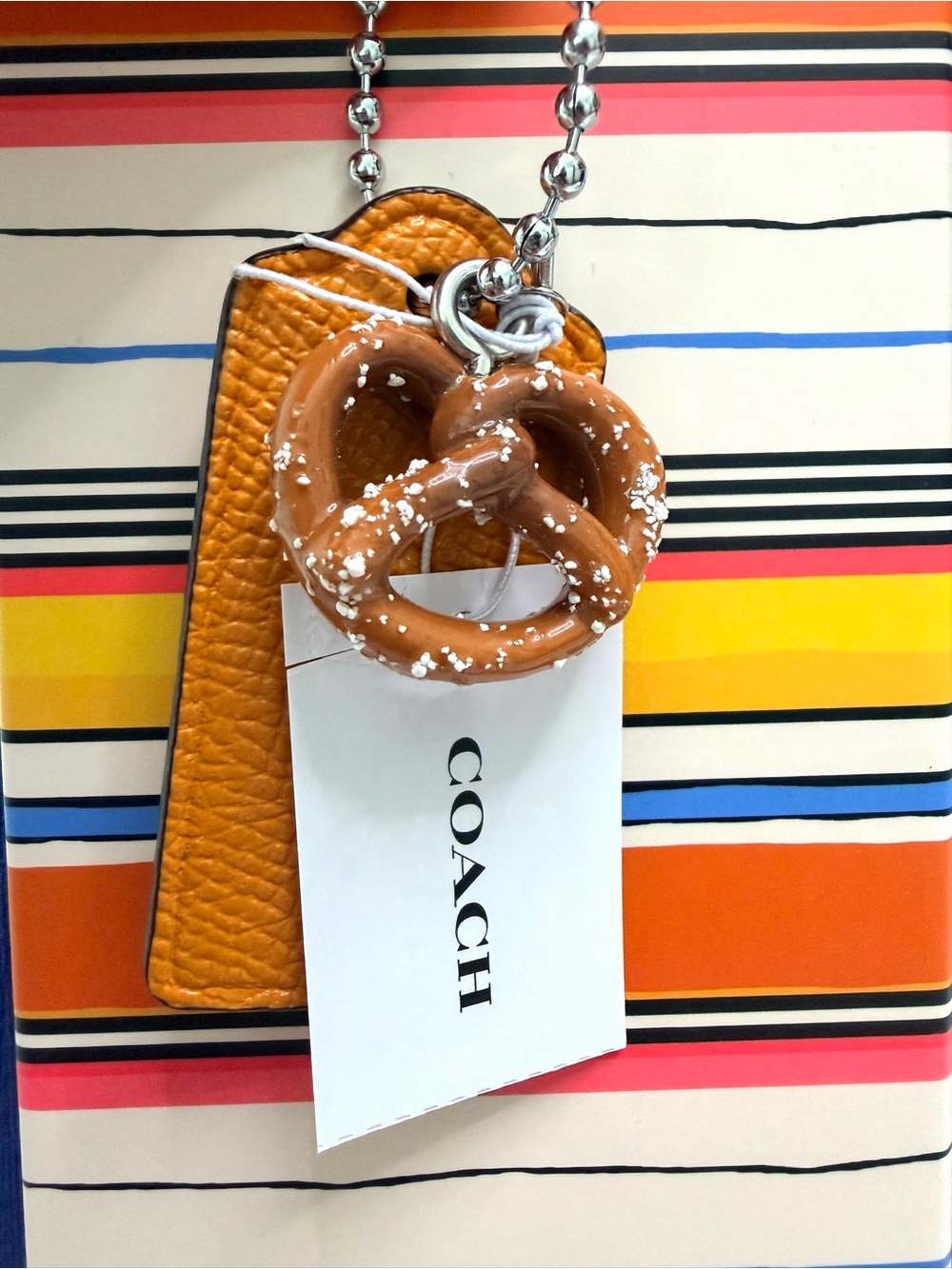 Coach Orange Leather Tag Keychain with Brown Pretzel Charm